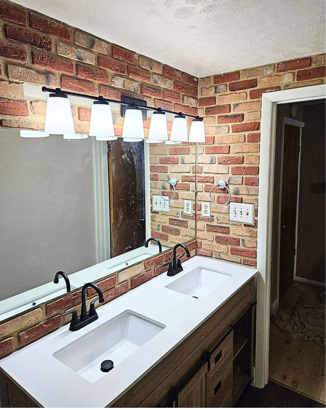 Modern double vanity with brick accent wall — after Wahl remodel