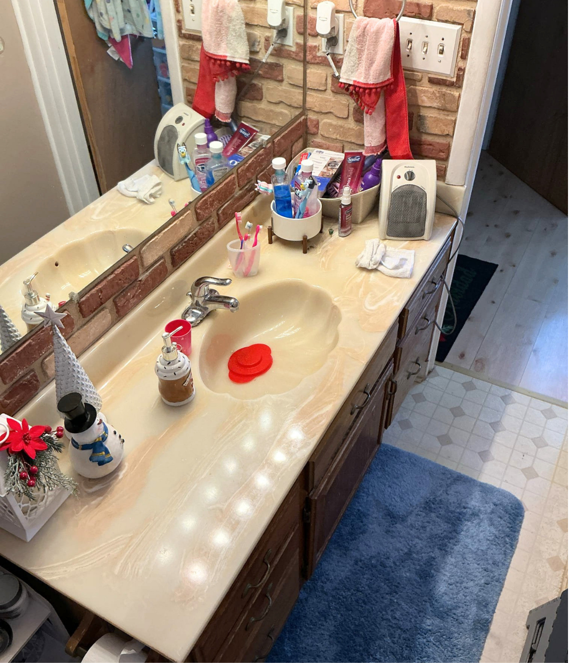 Cluttered single vanity bathroom — before Wahl remodel