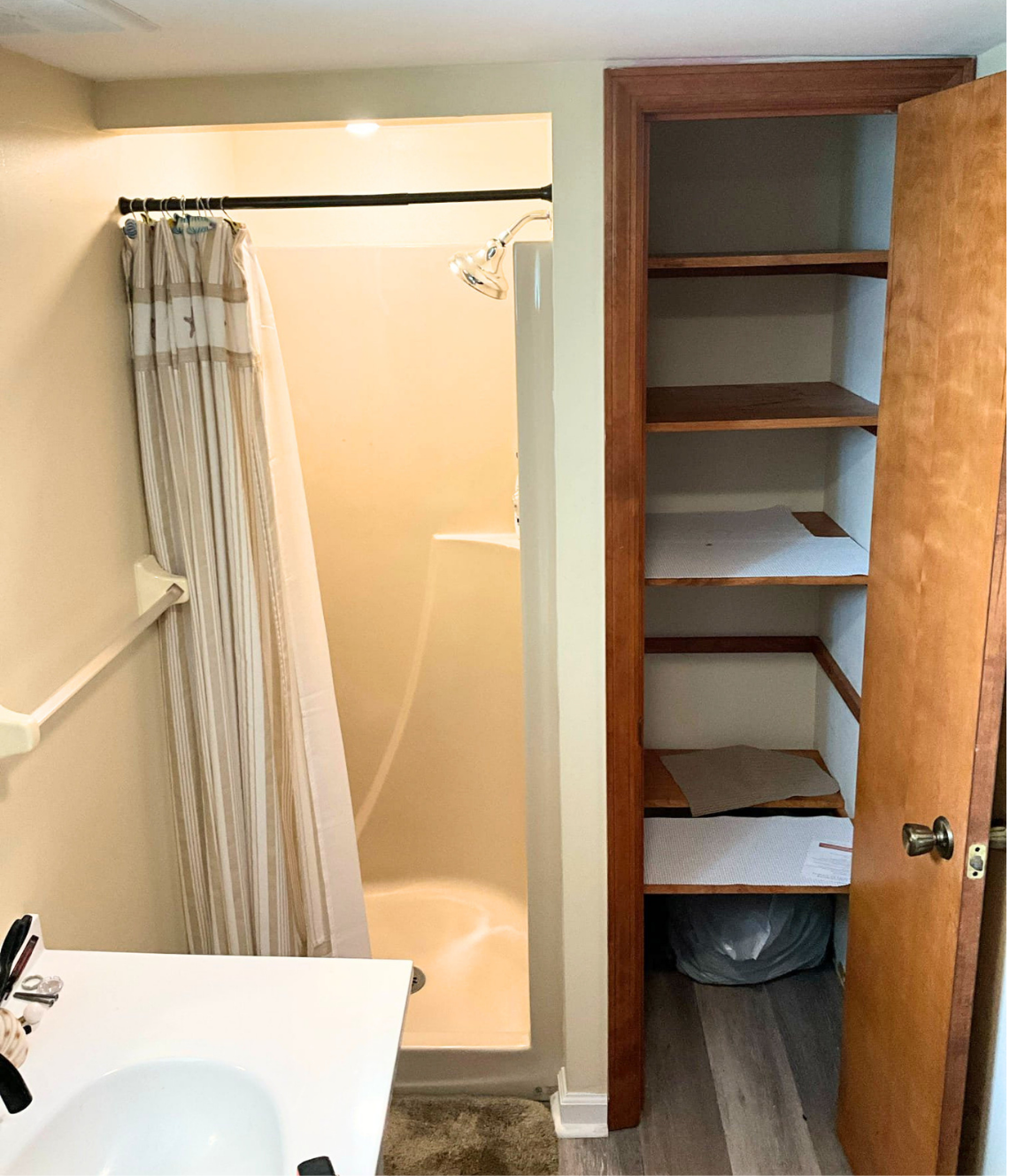 Cramped bathroom with closet adjacent to shower — before Wahl remodel